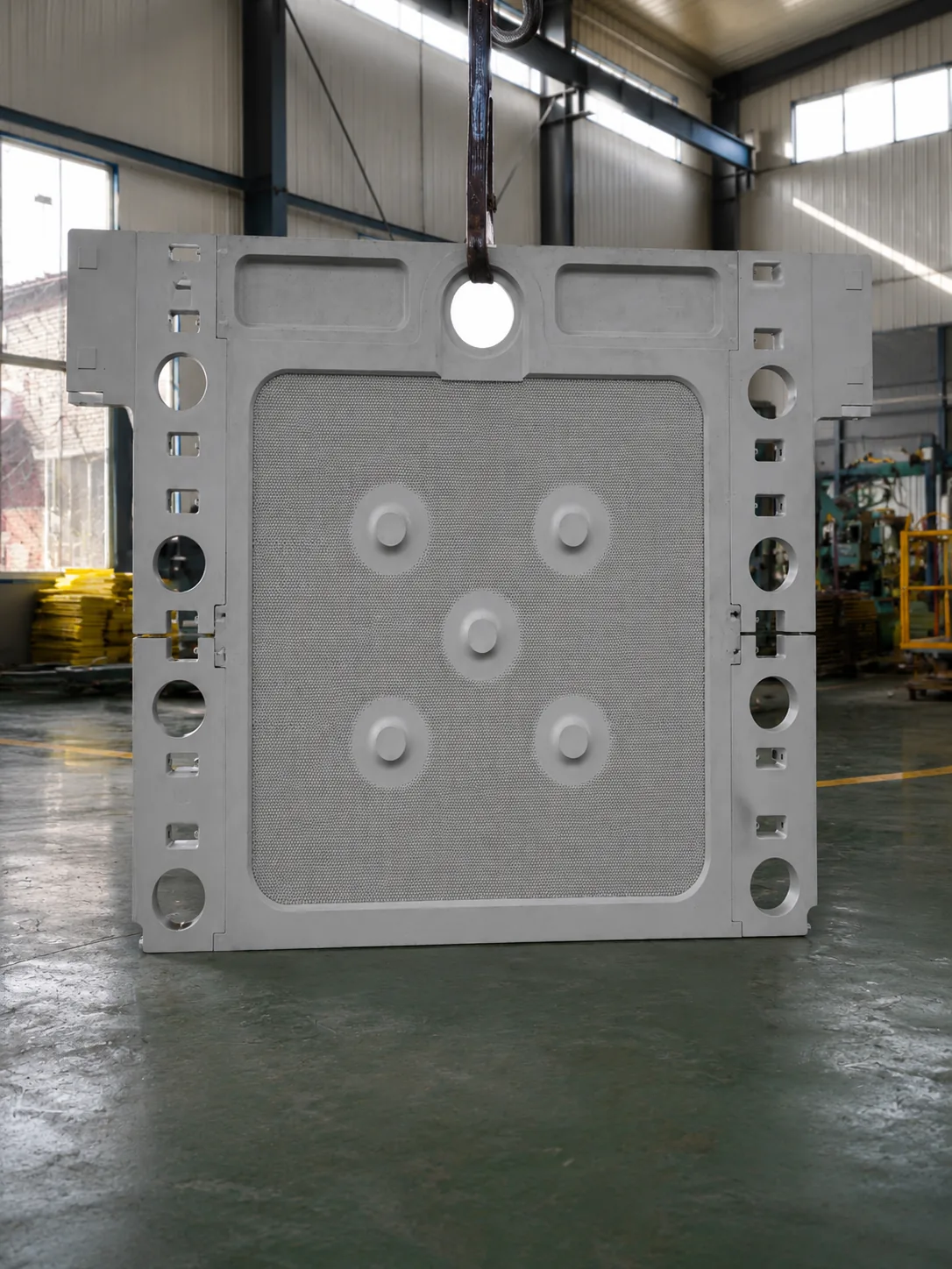 White FFP2512 membrane filter plate lifted in factory